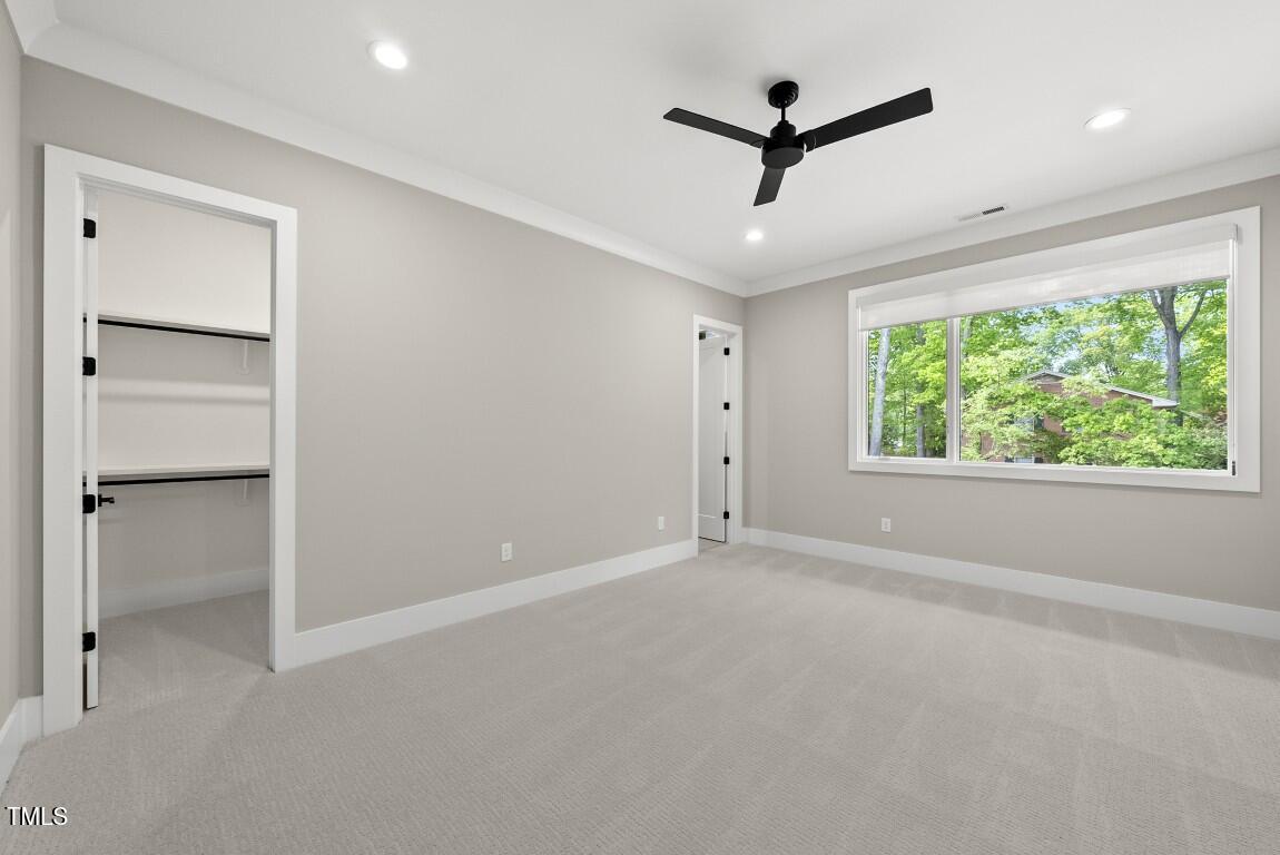 4139 Rockingham Drive Raleigh, NC 27609 - Photo 51 of 77 a view of room with window and a ceiling fan