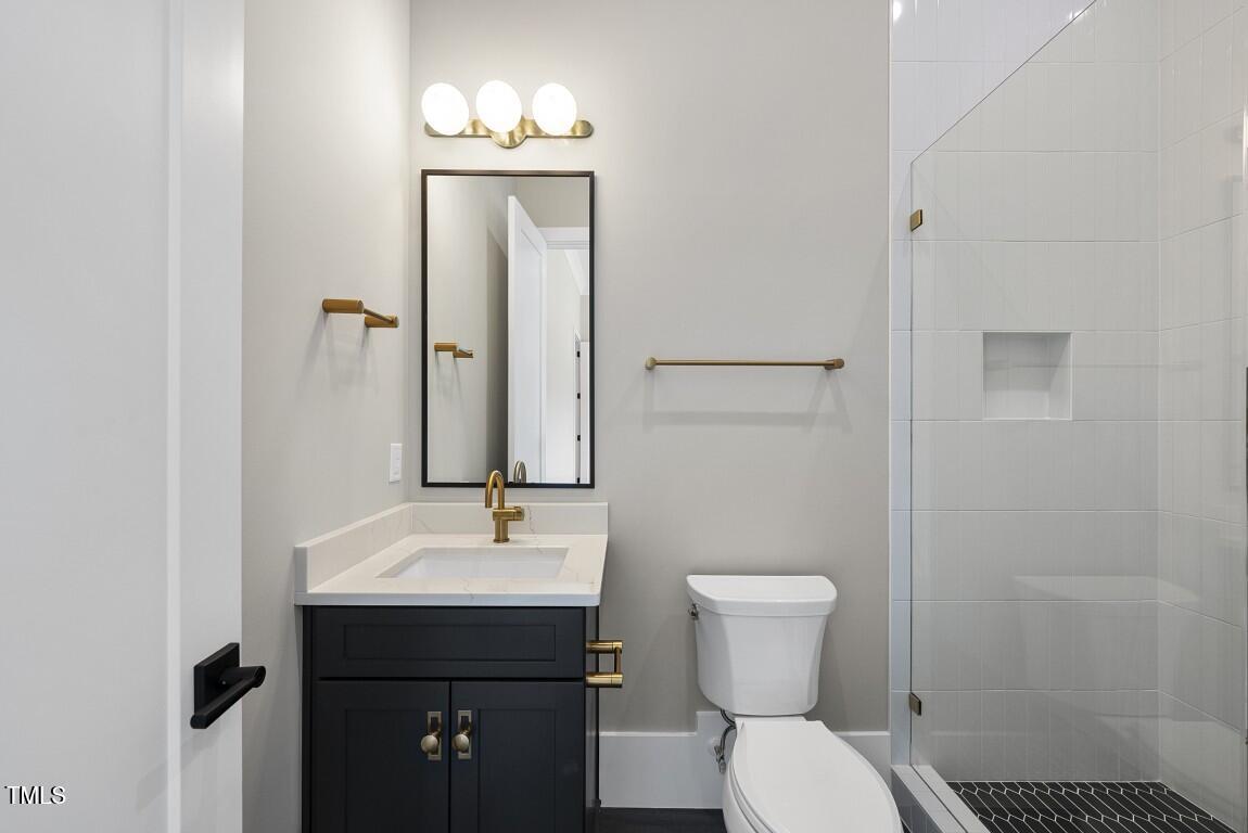 4139 Rockingham Drive Raleigh, NC 27609 - Photo 58 of 77 a bathroom with a sink toilet and mirror