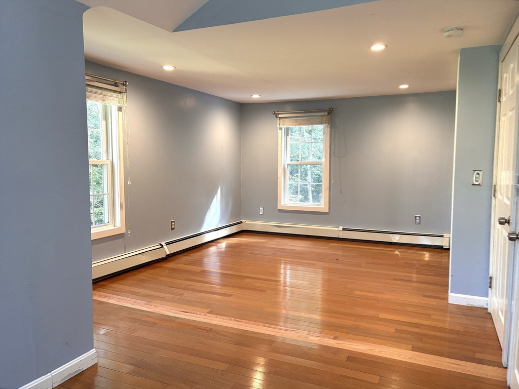 1694 Round Top Road Burrillville, RI 02830 - Photo 12 of 28 a view of an empty room with wooden floor and a window