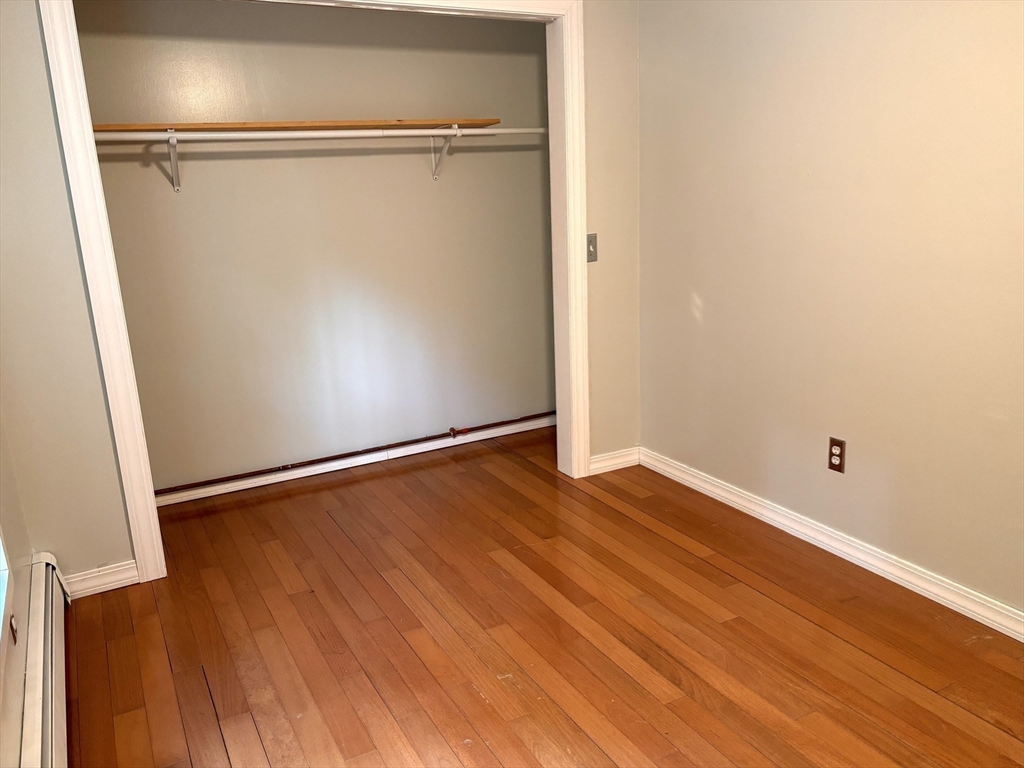1694 Round Top Road Burrillville, RI 02830 - Photo 14 of 28 an empty room with wooden floor