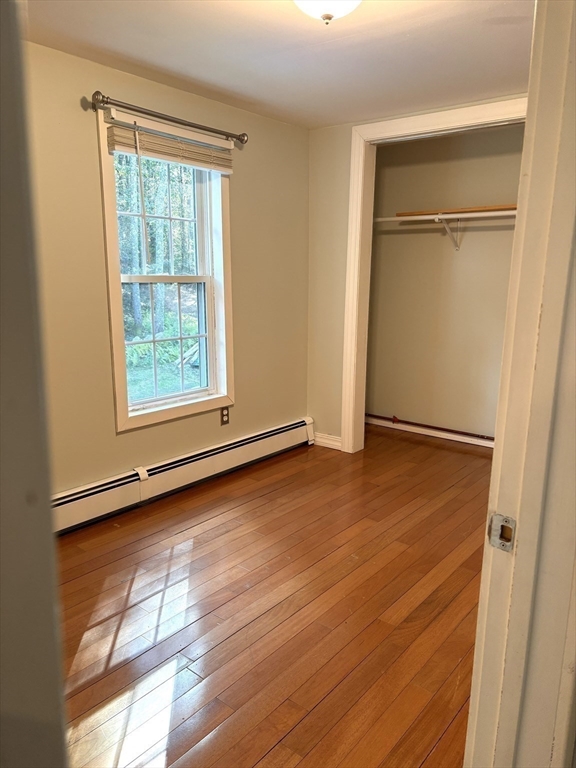 1694 Round Top Road Burrillville, RI 02830 - Photo 15 of 28 a view of an empty room with wooden floor and a window