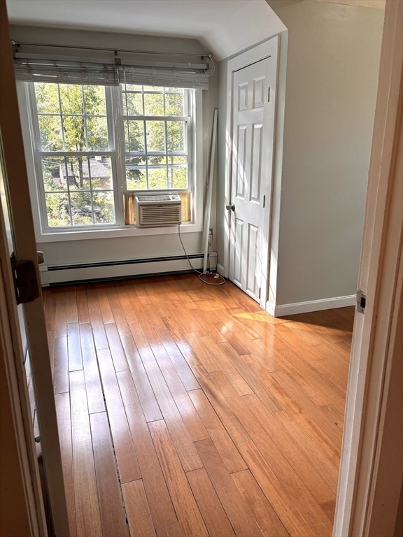 1694 Round Top Road Burrillville, RI 02830 - Photo 17 of 28 a view of an empty room with wooden floor and a window