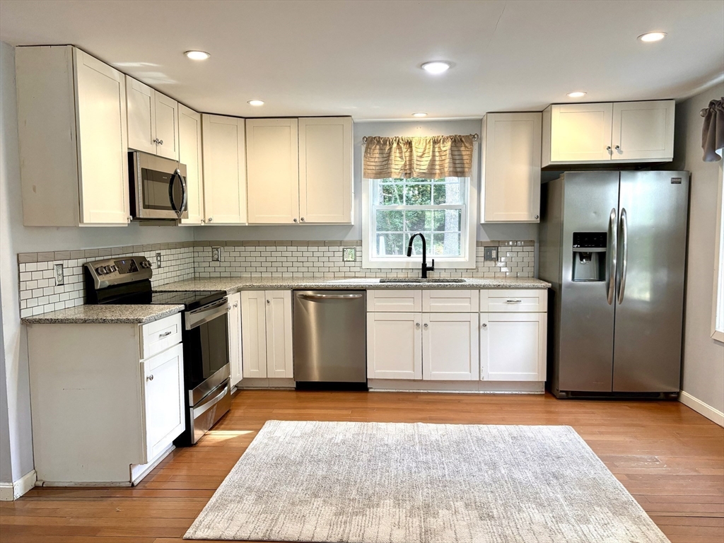 1694 Round Top Road Burrillville, RI 02830 - Photo 2 of 28 a kitchen with stainless steel appliances granite countertop a stove a sink dishwasher a refrigerator and a microwave