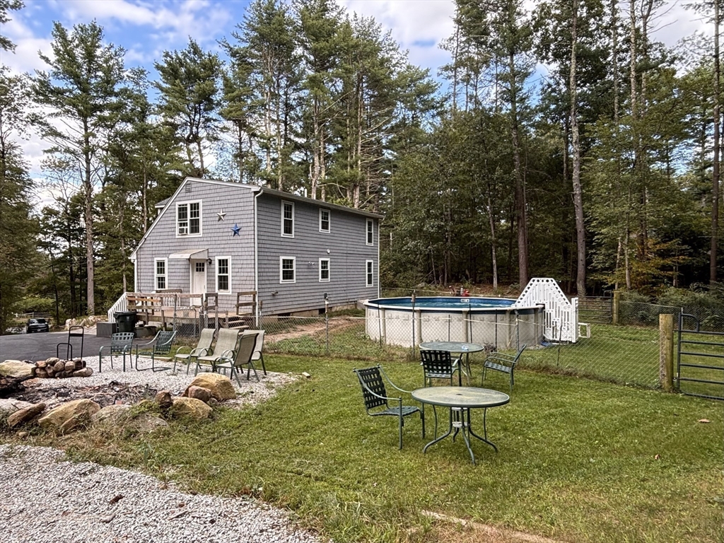 1694 Round Top Road Burrillville, RI 02830 - Photo 25 of 28 a view of a white house with a yard patio and fire pit
