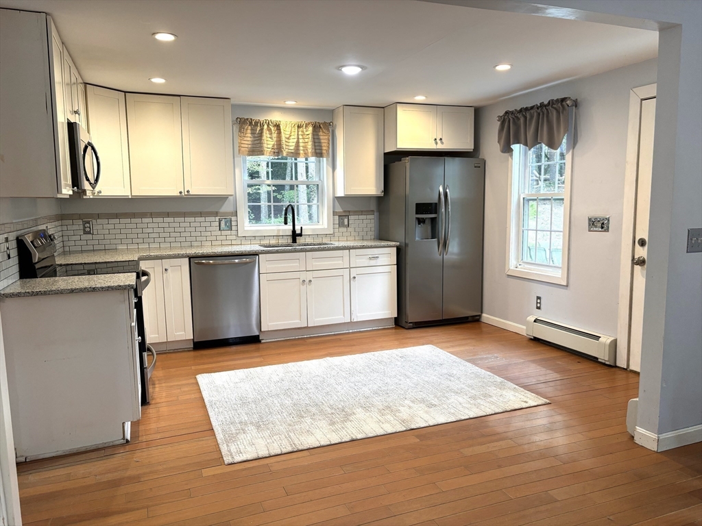 1694 Round Top Road Burrillville, RI 02830 - Photo 3 of 28 a kitchen with stainless steel appliances granite countertop a sink stove and refrigerator