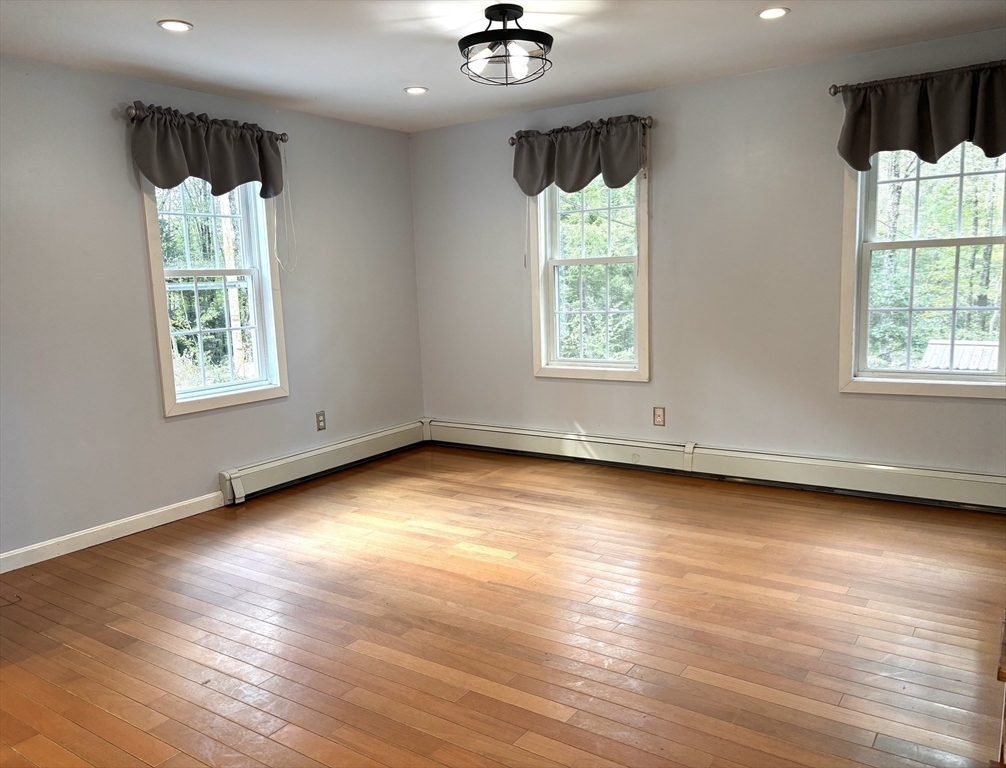 1694 Round Top Road Burrillville, RI 02830 - Photo 5 of 28 an empty room with wooden floor and windows
