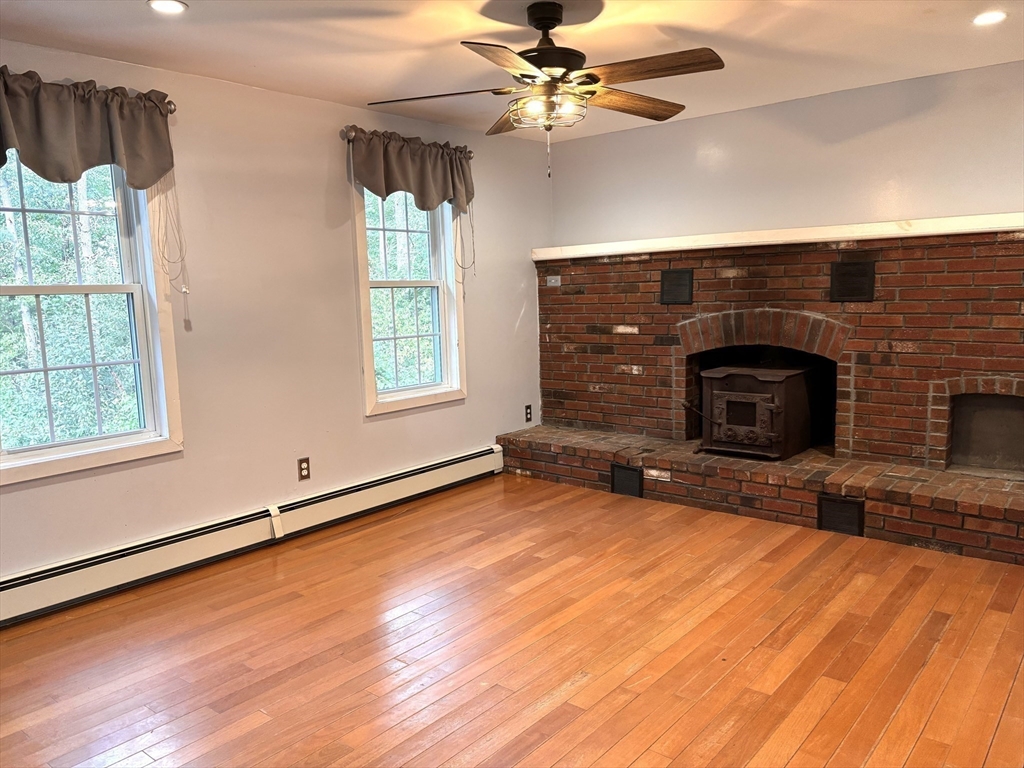 1694 Round Top Road Burrillville, RI 02830 - Photo 8 of 28 a living room with furniture and a fireplace