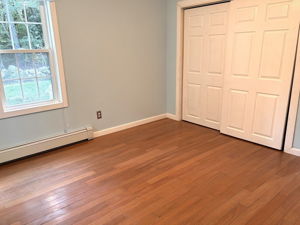 1694 Round Top Road Burrillville, RI 02830 - Photo 9 of 28 an empty room with wooden floor and windows