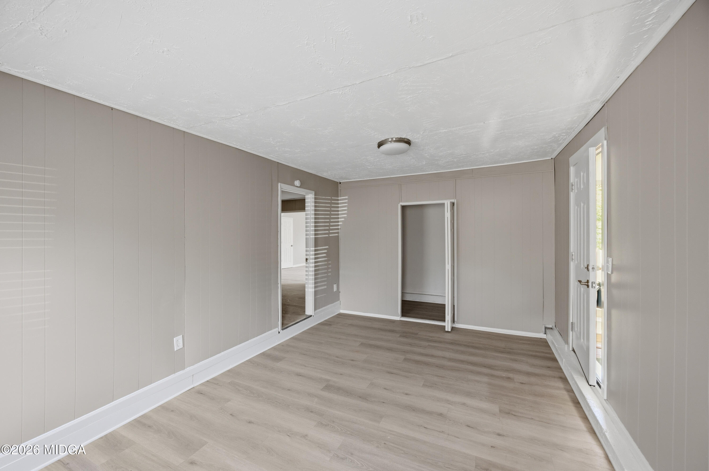 427 Gun Club Road Fort Valley, GA 31030 - Photo 21 of 26 a view of an empty room with wooden floor and closet