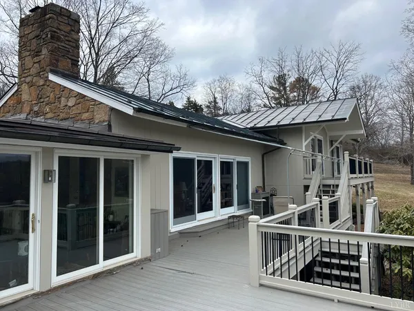 a view of a house with a wooden fence