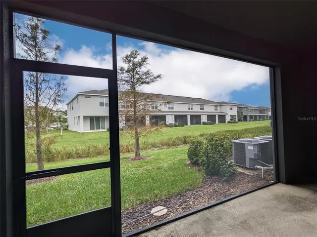 a view of a porch with furniture and garden