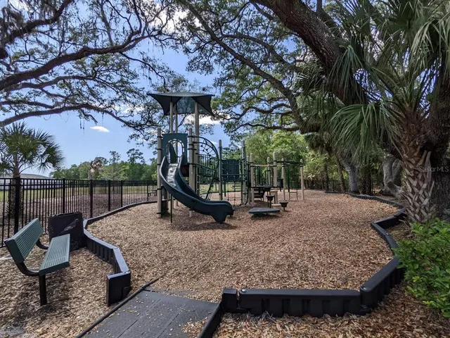 a view of a park with iron fence