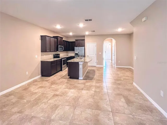 a view of kitchen with stainless steel appliances a living room