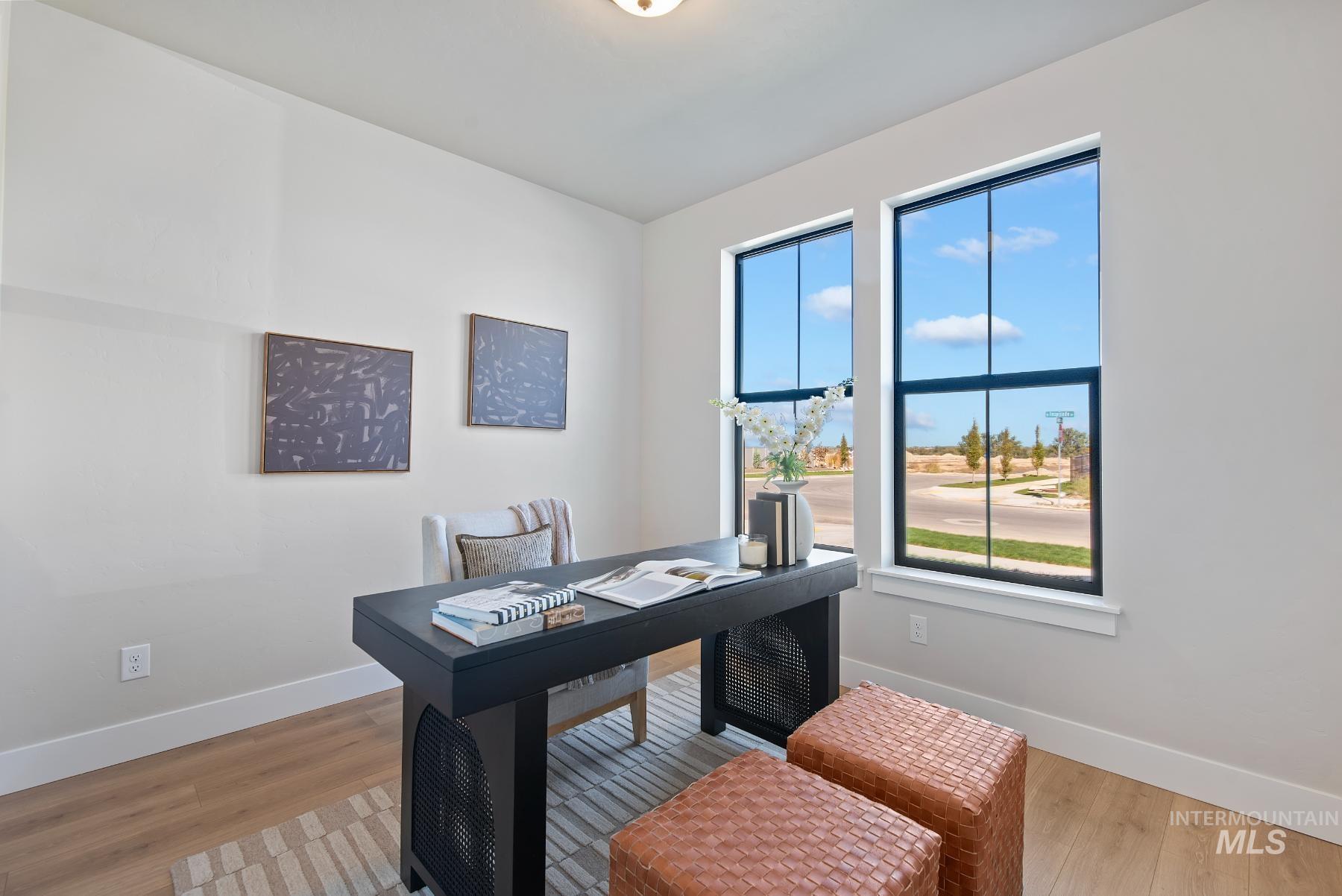 8410 West Graye Street, Unit ALPINE Meridian, ID 83646 - Photo 27 of 45 Room featuring wood-finish flooring, white baseboards, and a single window with white trim