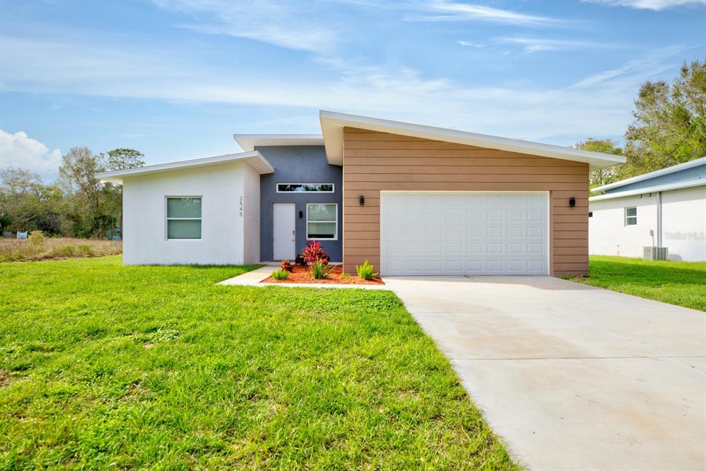 2545 Odessa Road Avon Park, FL 33825 - Photo 1 of 33 a front view of house with yard and garage