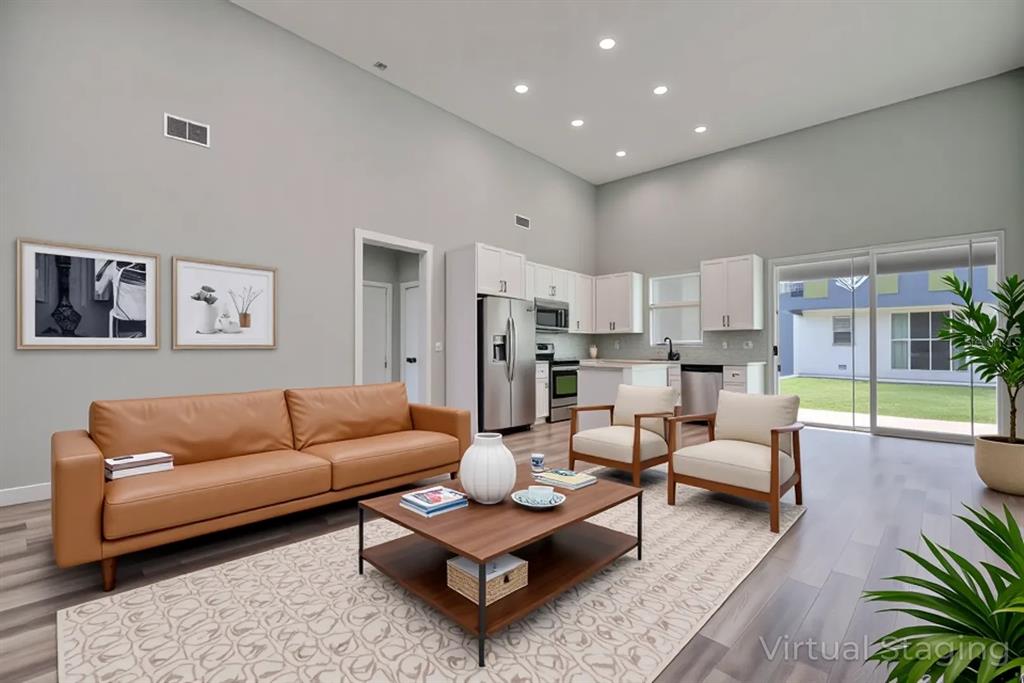 2545 Odessa Road Avon Park, FL 33825 - Photo 4 of 33 a living room with furniture kitchen view and a rug