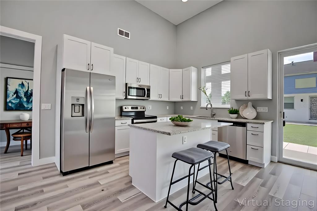 2545 Odessa Road Avon Park, FL 33825 - Photo 5 of 33 a kitchen with stainless steel appliances a refrigerator sink and white cabinets
