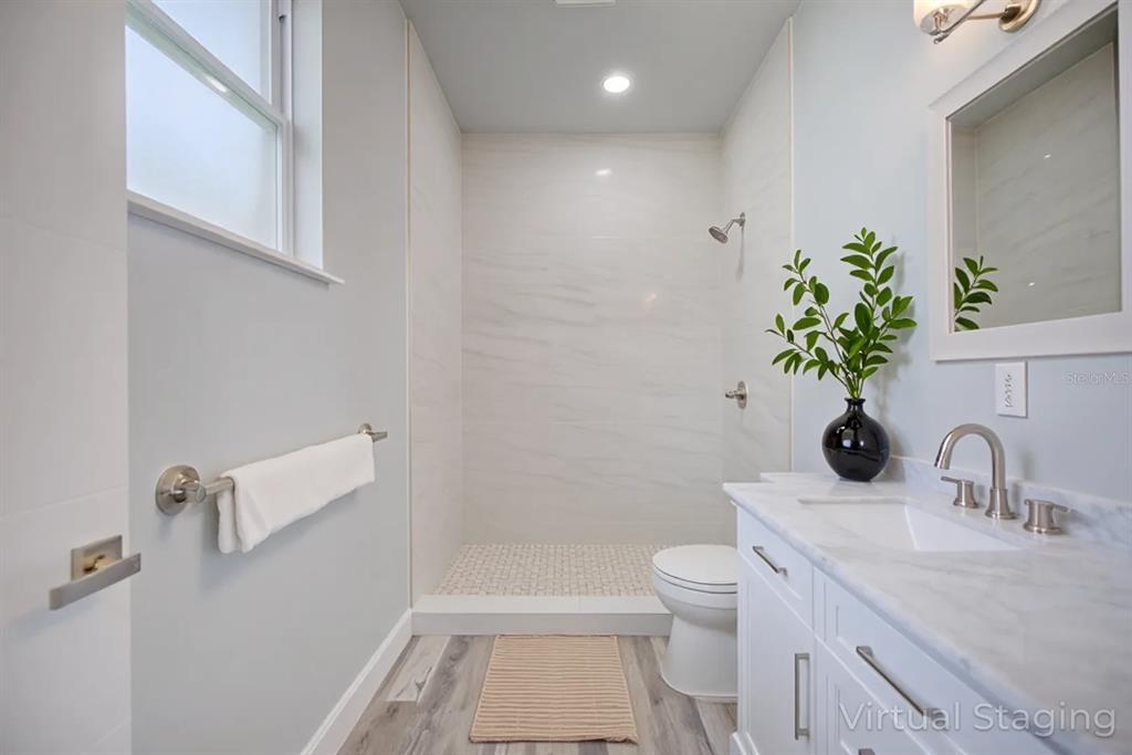2545 Odessa Road Avon Park, FL 33825 - Photo 8 of 33 a bathroom with a sink a toilet and a mirror