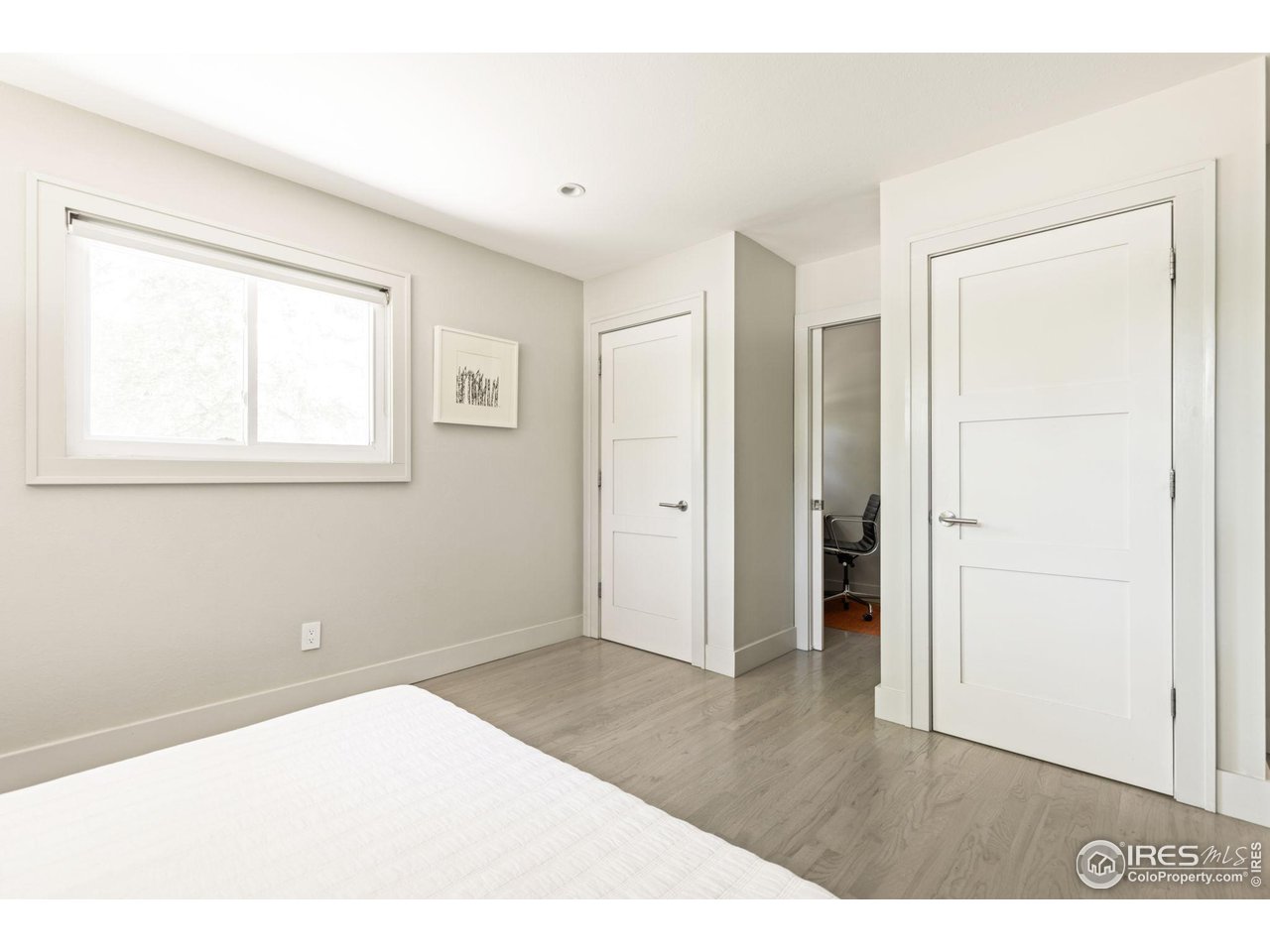 7705 Baseline Road Boulder, CO 80303 - Photo 16 of 40 a view of an empty room with wooden floor and a window