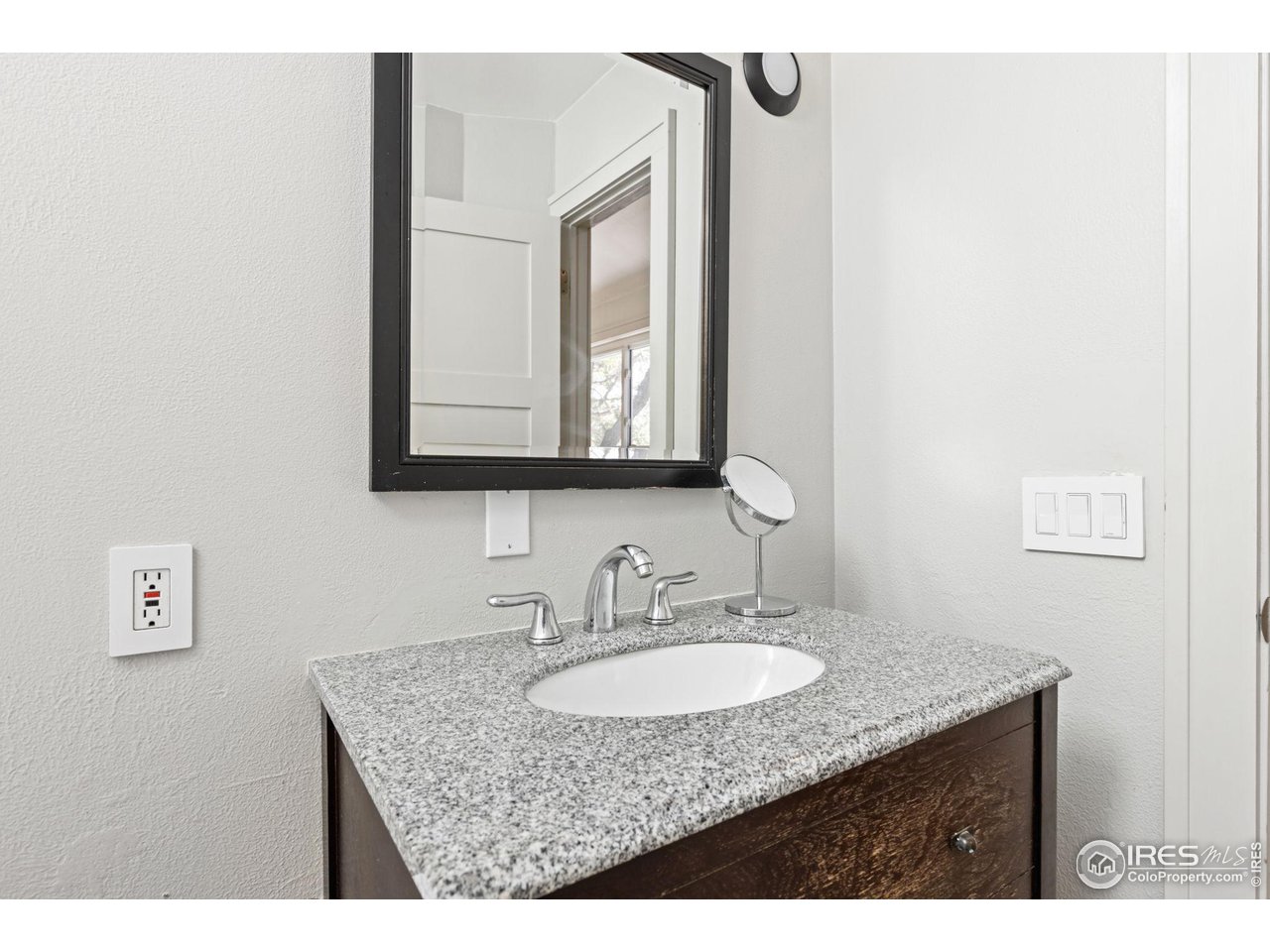 7705 Baseline Road Boulder, CO 80303 - Photo 26 of 40 a bathroom with a granite countertop sink and a mirror