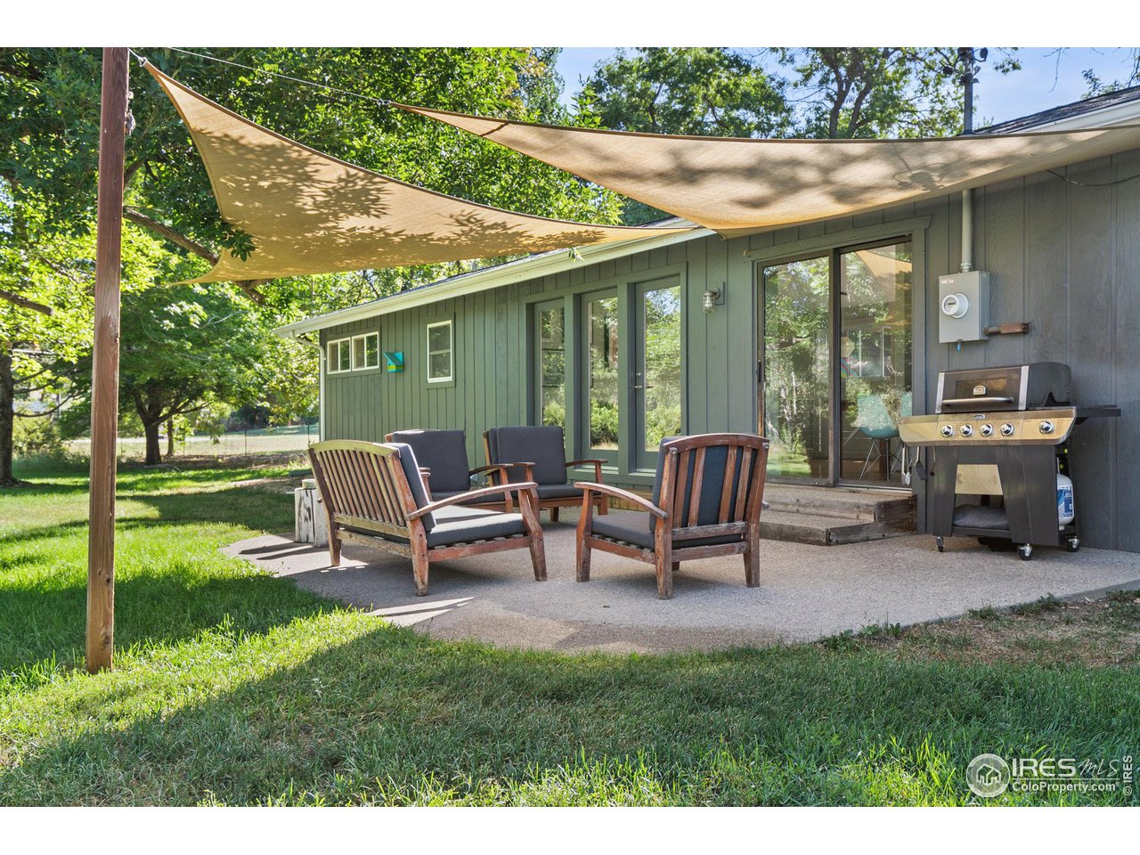 7705 Baseline Road Boulder, CO 80303 - Photo 31 of 40 a view of a patio with table and chairs next to a yard