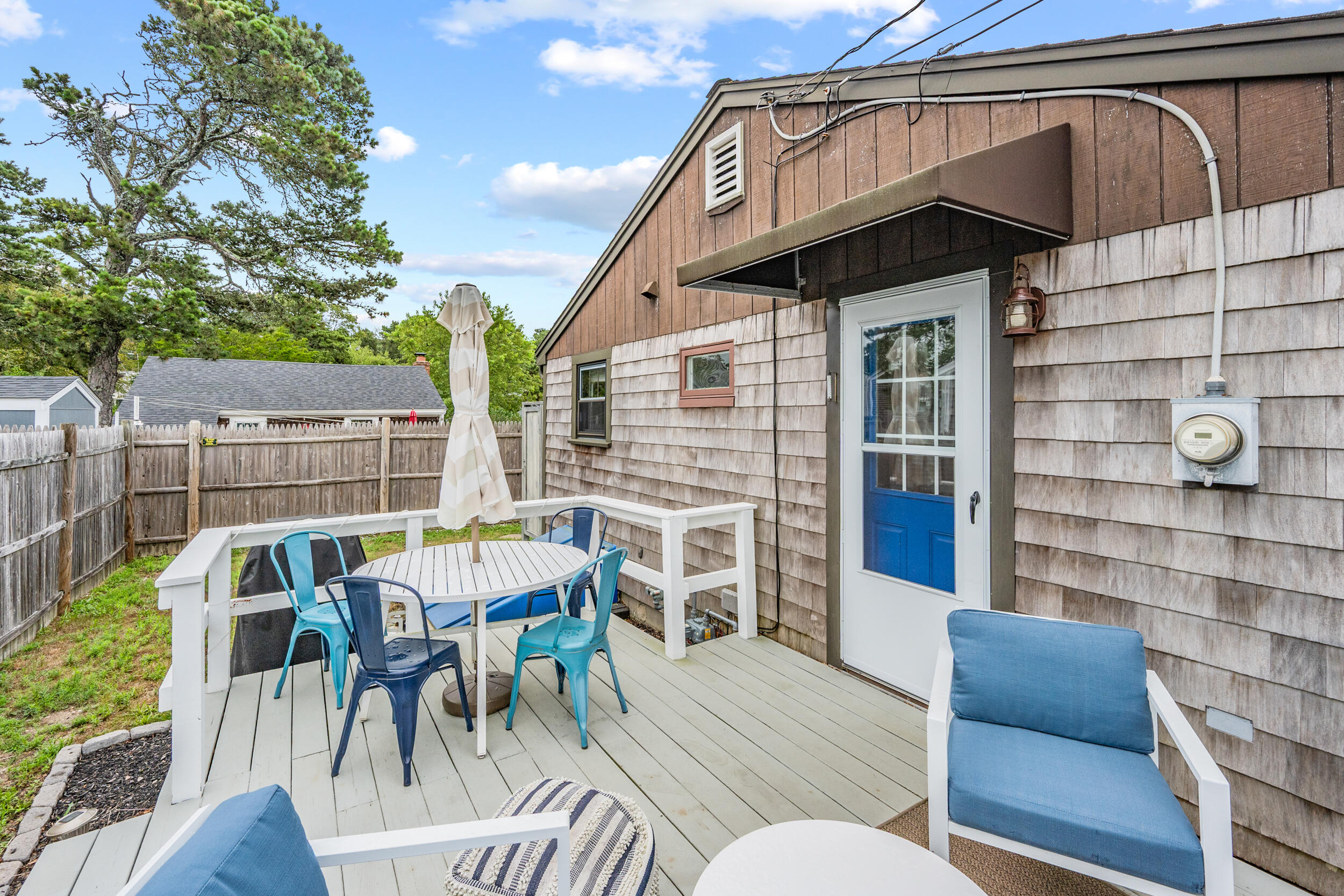 22 Wixon Road Dennis Port, MA 02639 - Photo 22 of 28 a view of a patio with table and chairs with wooden floor and fence