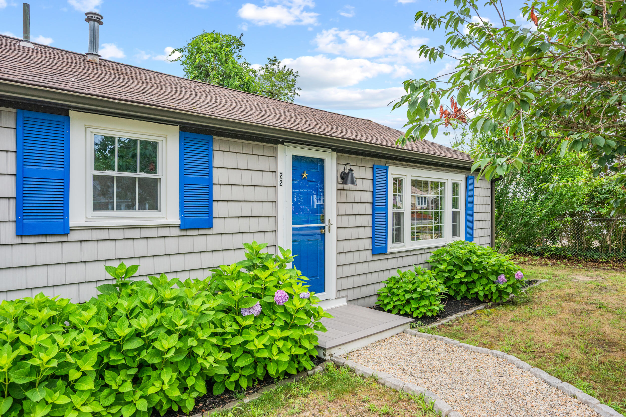22 Wixon Road Dennis Port, MA 02639 - Photo 3 of 28 a house with a flower garden