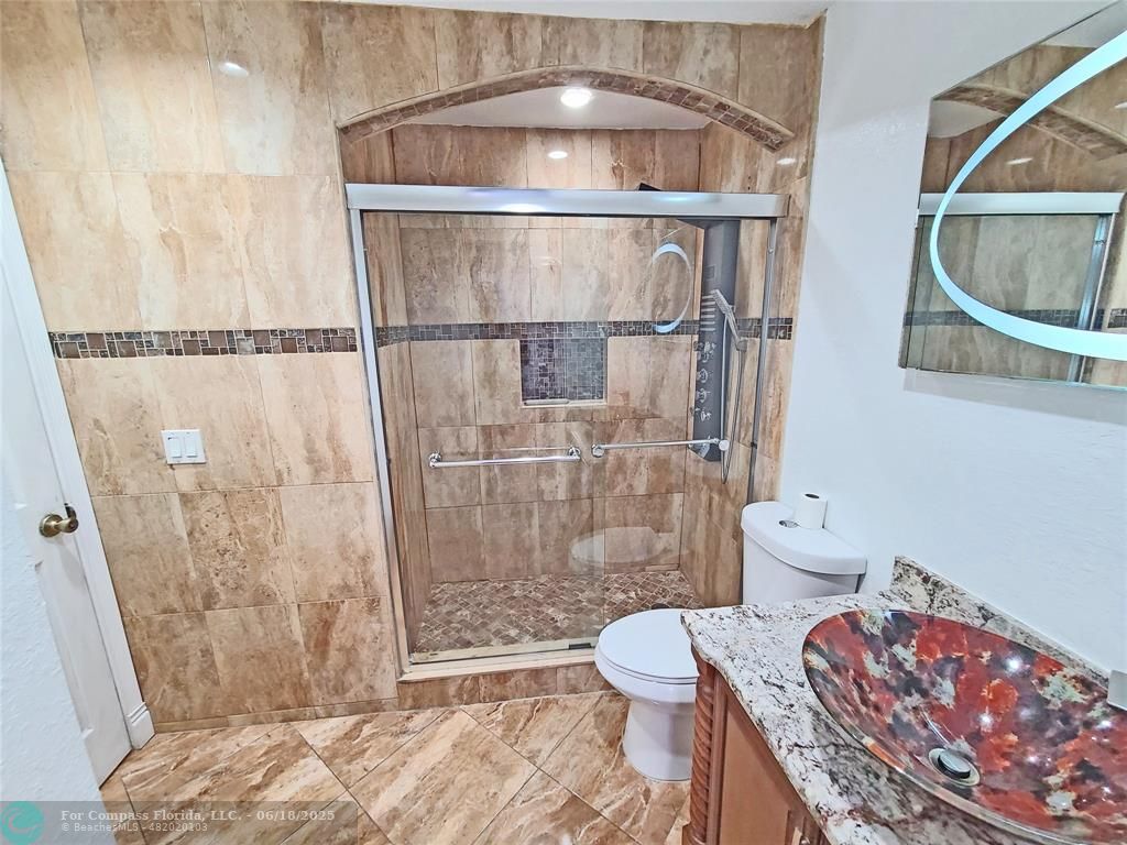 139 Sparrow Drive, Unit 4B Royal Palm Beach, FL 33411 - Photo 13 of 48 a bathroom with a toilet and a shower