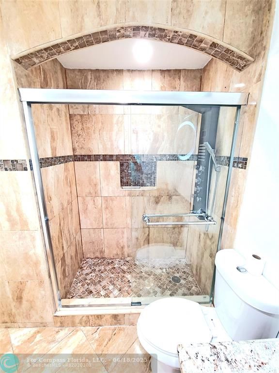 139 Sparrow Drive, Unit 4B Royal Palm Beach, FL 33411 - Photo 14 of 48 a bathroom with a bathtub and shower