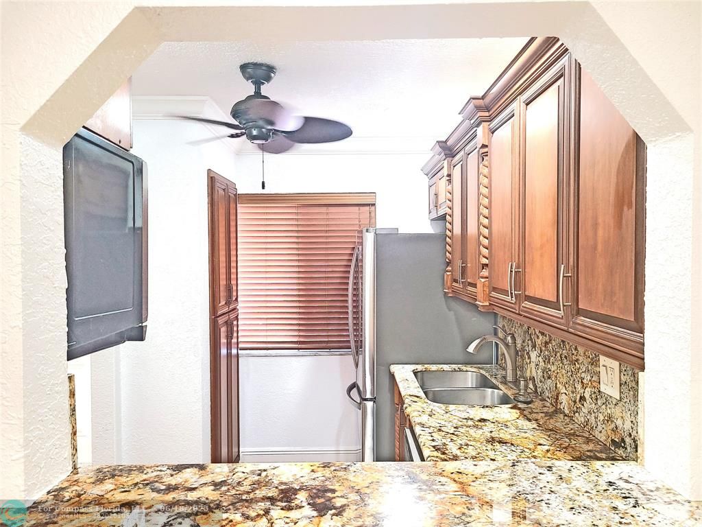 139 Sparrow Drive, Unit 4B Royal Palm Beach, FL 33411 - Photo 2 of 48 a bathroom with a granite countertop sink and a window