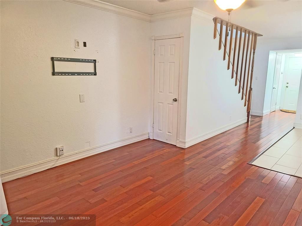 139 Sparrow Drive, Unit 4B Royal Palm Beach, FL 33411 - Photo 37 of 48 an empty room with wooden floor and windows