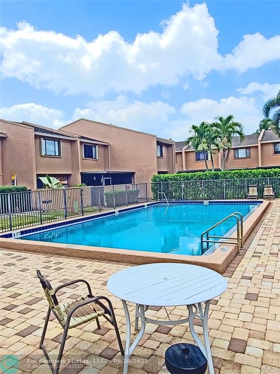 139 Sparrow Drive, Unit 4B Royal Palm Beach, FL 33411 - Photo 45 of 48 a view of a swimming pool with a lounge chairs
