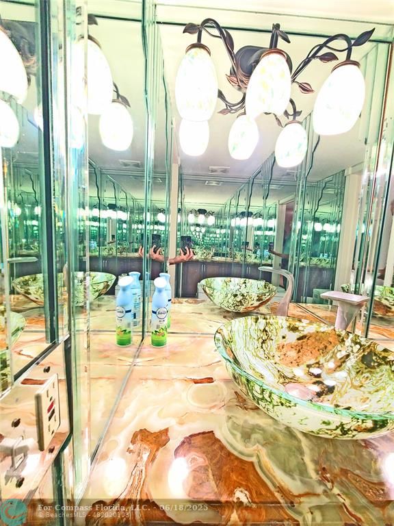 139 Sparrow Drive, Unit 4B Royal Palm Beach, FL 33411 - Photo 46 of 48 a view of a swimming pool with a dining table chairs and chandelier