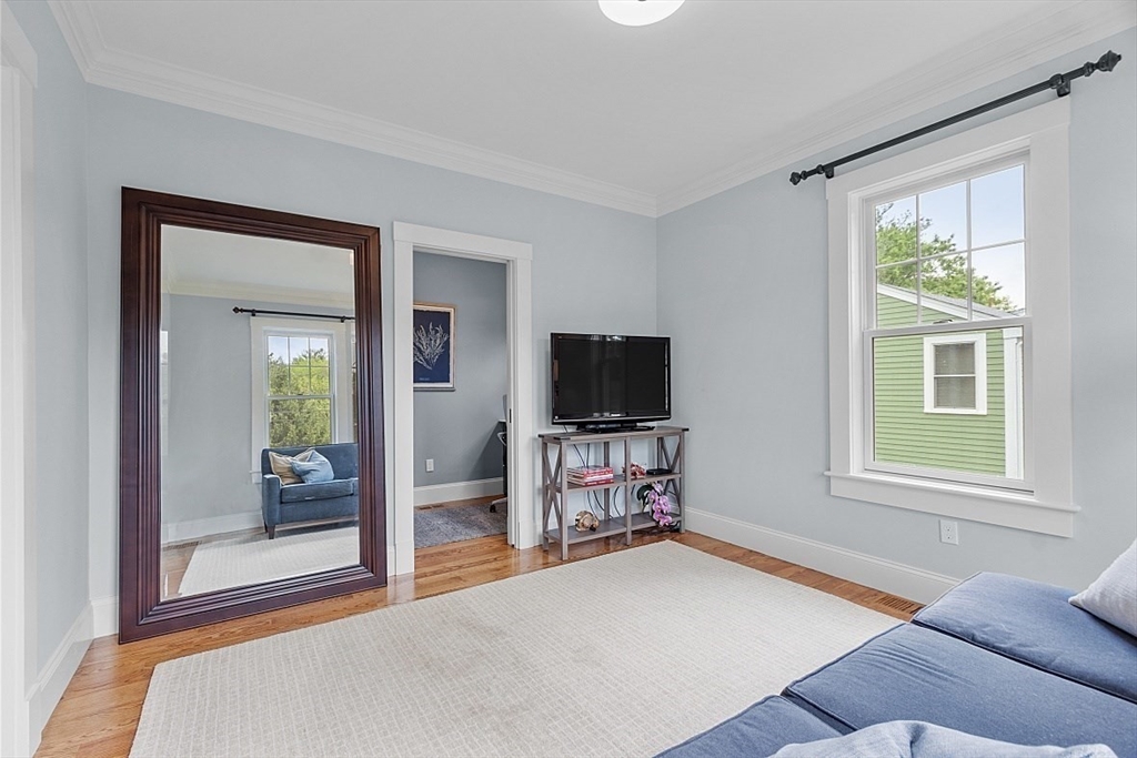 63 Thornton Road Needham, MA 02492 - Photo 15 of 41 a bedroom with a bed and a flat screen tv