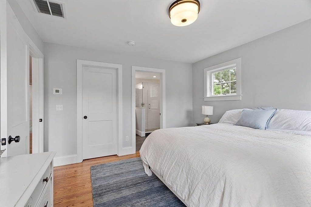 63 Thornton Road Needham, MA 02492 - Photo 25 of 41 a bedroom with a bed and a chandelier