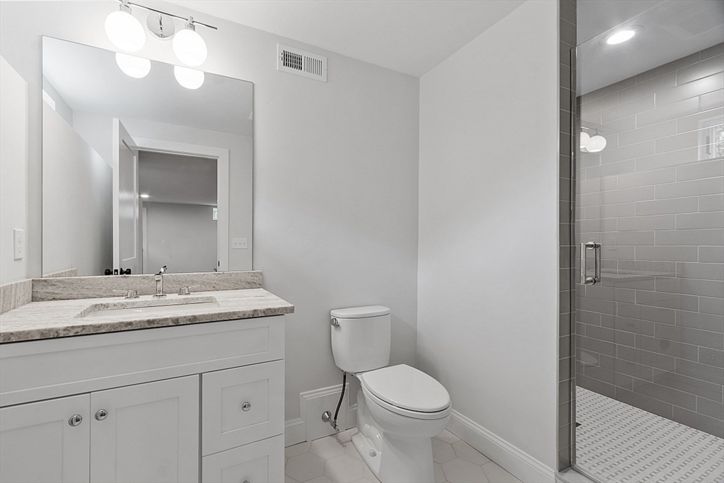 63 Thornton Road Needham, MA 02492 - Photo 35 of 41 a bathroom with a granite countertop sink mirror vanity and toilet