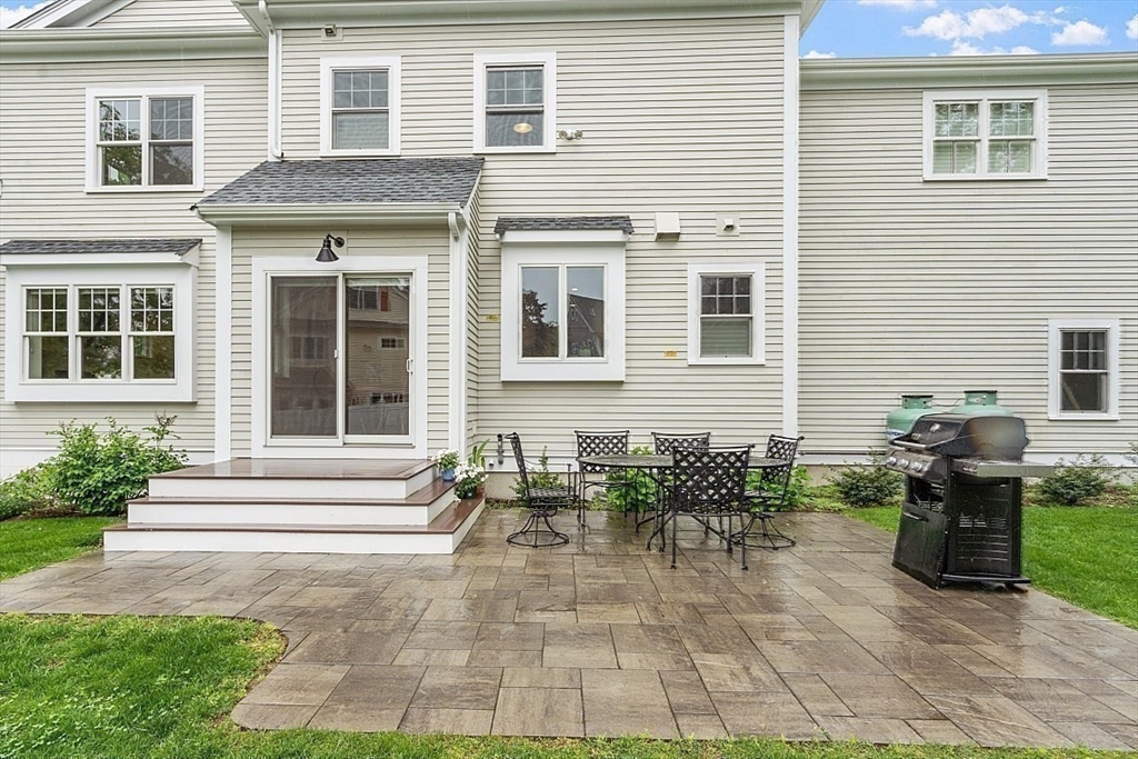 63 Thornton Road Needham, MA 02492 - Photo 39 of 41 a backyard of a house with table and chairs