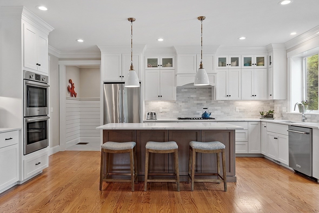 63 Thornton Road Needham, MA 02492 - Photo 6 of 41 a kitchen with stainless steel appliances granite countertop a white cabinets and wooden floor