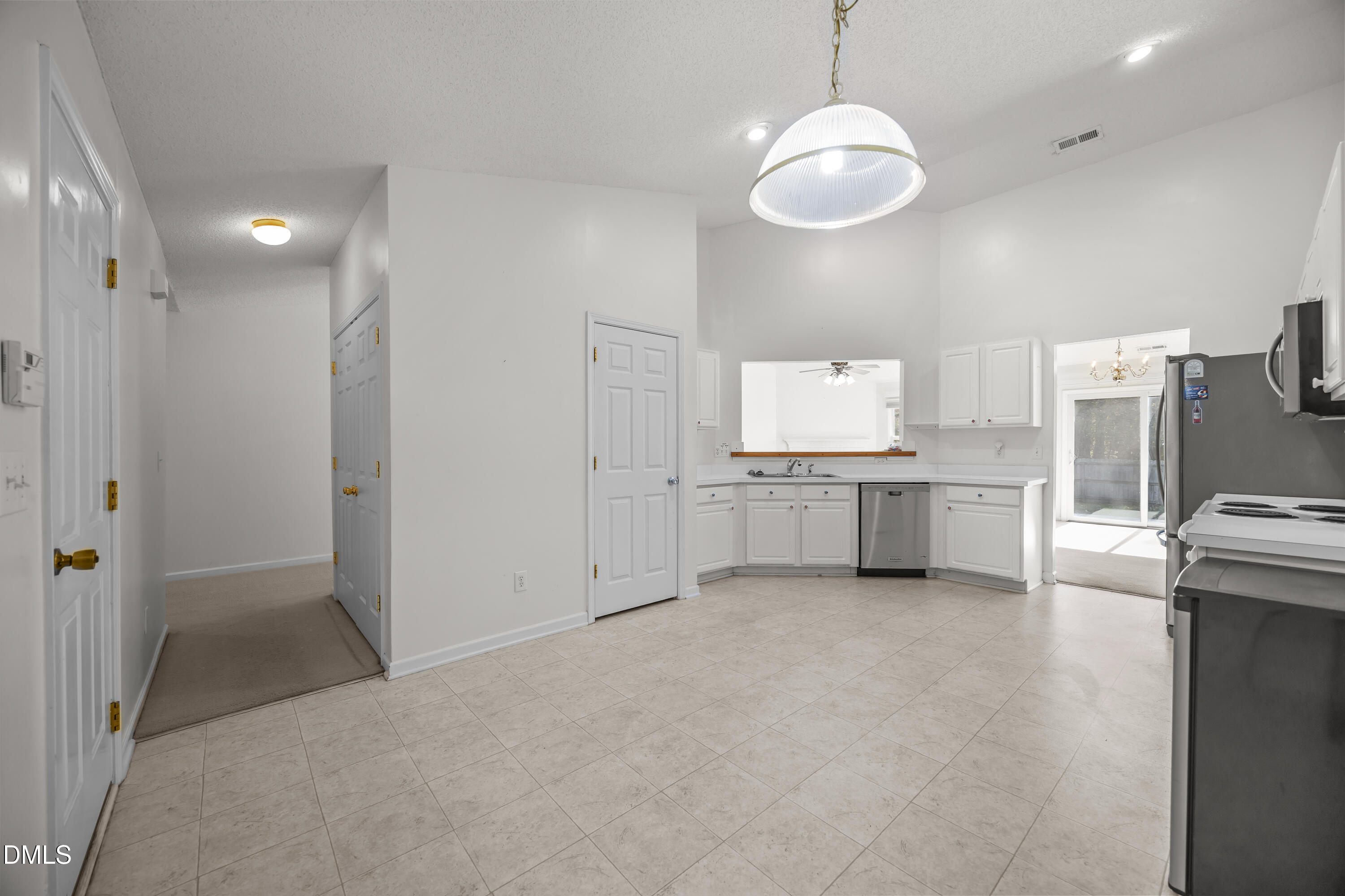 7604 Brighton Village Drive Raleigh, NC 27616 - Photo 11 of 30 a view of a kitchen with a sink and dishwasher a refrigerator with wooden floor
