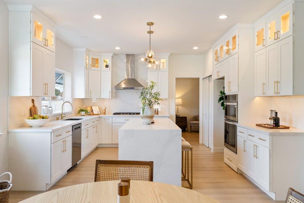 10496 South Stelling Road Cupertino, CA 95014 - Photo 15 of 54 a kitchen with a sink a center island cabinets and a window