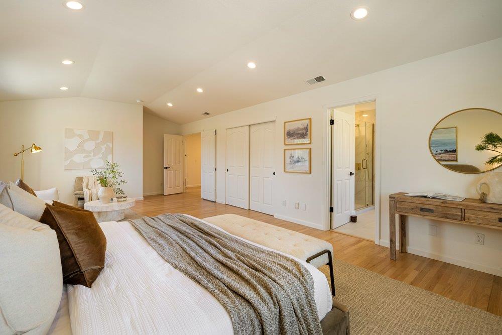 10496 South Stelling Road Cupertino, CA 95014 - Photo 26 of 54 a spacious bedroom with a bed and a chandelier