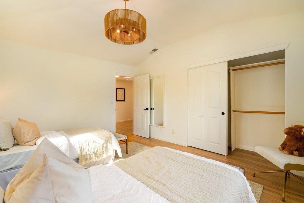 10496 South Stelling Road Cupertino, CA 95014 - Photo 32 of 54 a bedroom with a bed and a chandelier