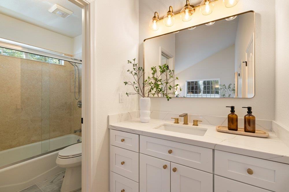 10496 South Stelling Road Cupertino, CA 95014 - Photo 41 of 54 a bathroom with a toilet a sink a mirror a shower and vanity