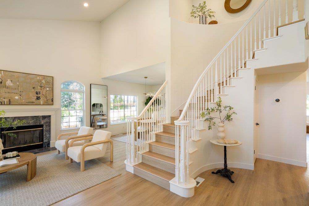 10496 South Stelling Road Cupertino, CA 95014 - Photo 5 of 54 a living room with fireplace furniture and a wooden floor