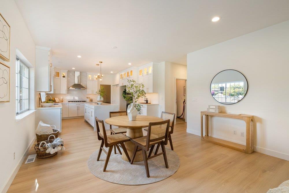 10496 South Stelling Road Cupertino, CA 95014 - Photo 9 of 54 a dining room with wooden floor a glass table and chairs