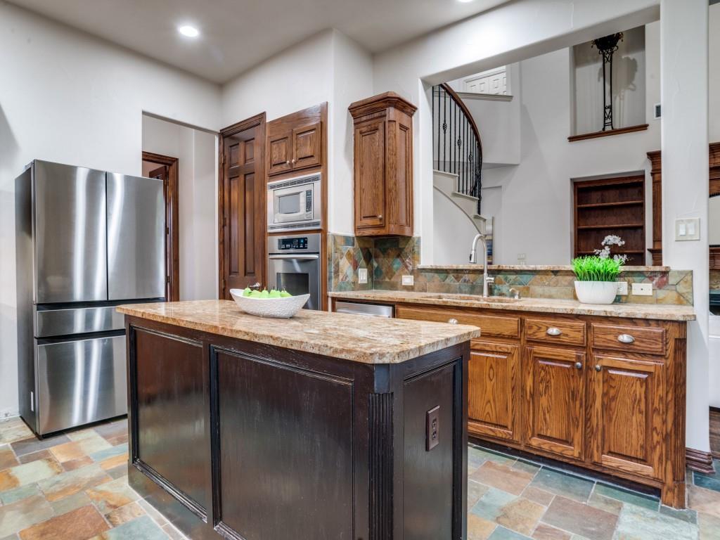 1908 Bordeaux Court Allen, TX 75002 - Photo 11 of 28 a kitchen with stainless steel appliances granite countertop a sink stove and refrigerator