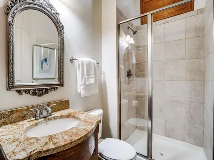 a bathroom with a sink toilet and shower