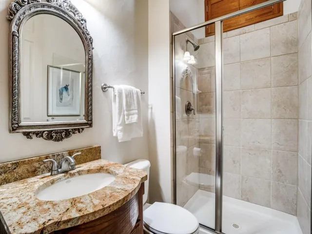 a bathroom with a sink toilet and shower