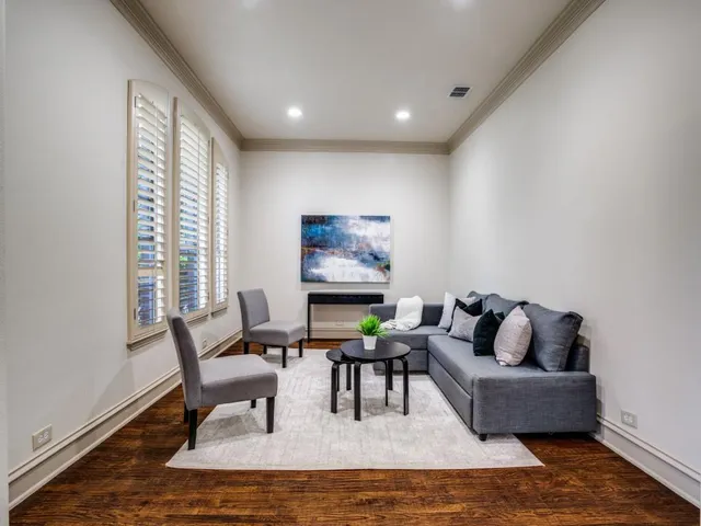 a living room with furniture and a floor to ceiling window
