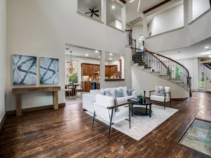 a living room with fireplace furniture and a wooden floor